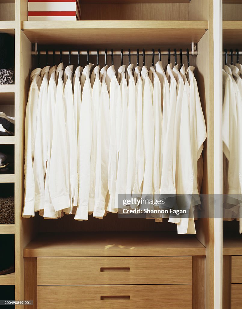 White shirts hanging in closet