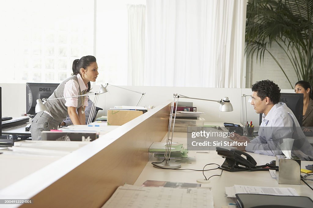 Businesswoman talking to colleague in office