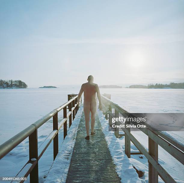 finland, helsinki, naked man walking along pier on frozen baltic sea - steam room stock pictures, royalty-free photos & images