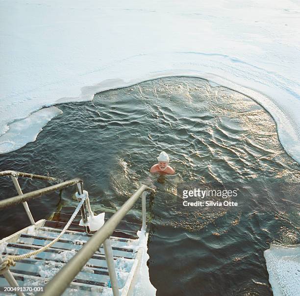 finland, helsinki, man ice water swimming in frozen baltic sea - frozen man stockfoto's en -beelden