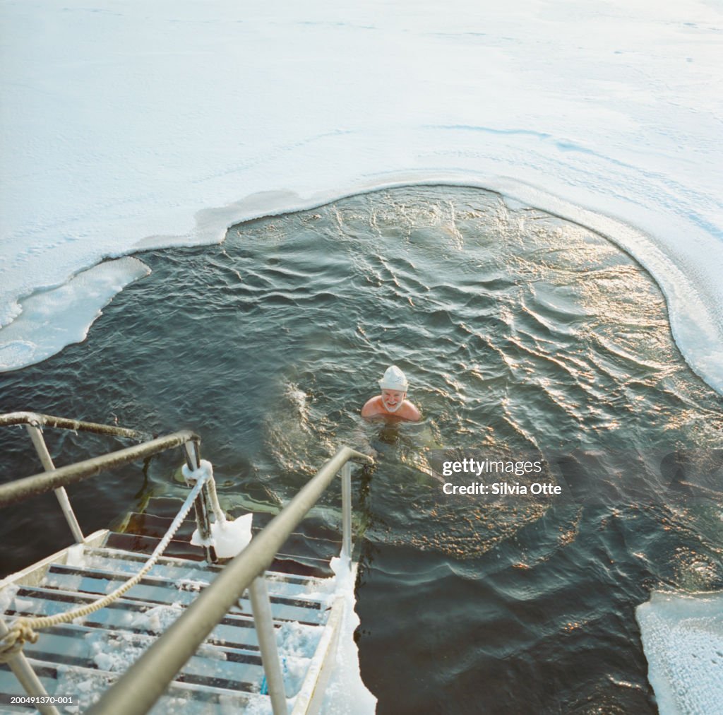 Finland, Helsinki, man ice water swimming in frozen Baltic Sea