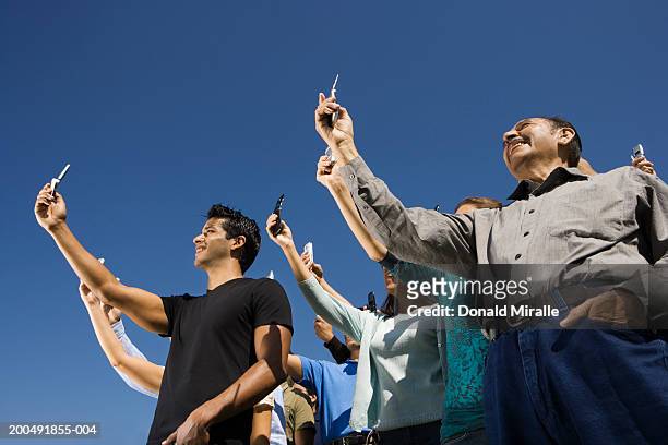 crowd with mobile phones, low angle view - holding above head stock pictures, royalty-free photos & images