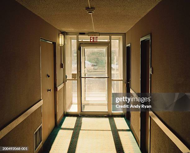 corridor leading to fire exit - 非常口 ストックフォトと画像