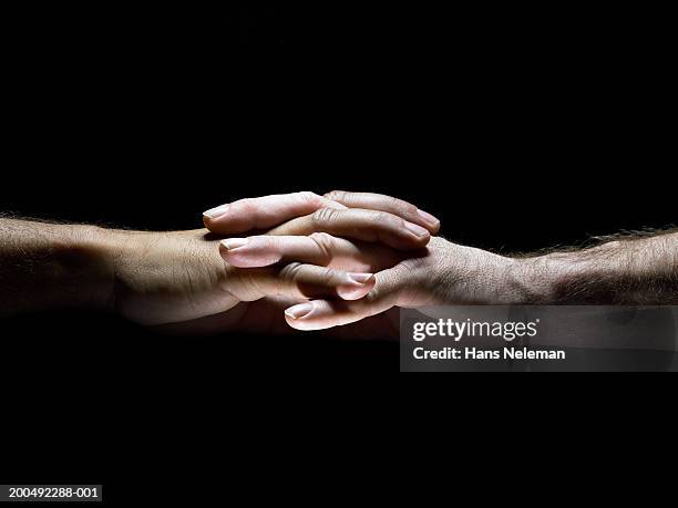 Hold hands  Two Hands Clasping Fingers Interlocked Closeup Side View High-Res