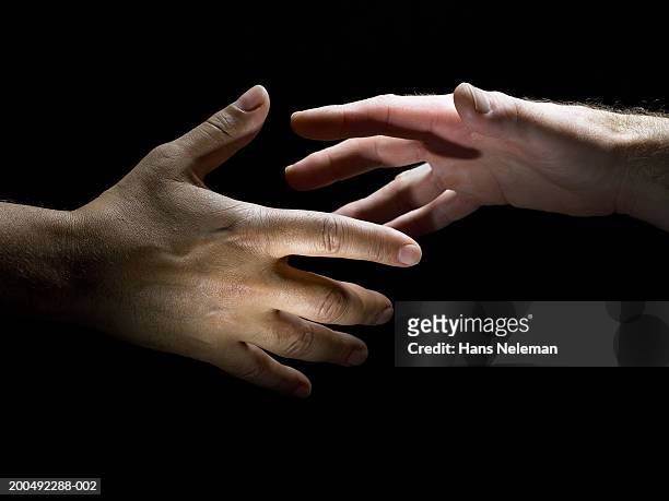 two male hands about to shake hands, close-up, side view - handshake close up stock-fotos und bilder