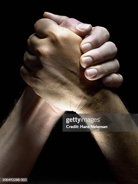 two men clasping hands, close-up, side view - gripping stock pictures, royalty-free photos & images