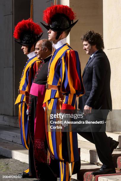Argentina's President Javier Milei exits the Vatican Apostolic Palace flanked by Monsignor Guillermo Karcher, following a meeting with Pope Francis,...