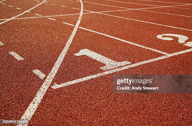 athletic track, lane one in foreground - track and field stock pictures, royalty-free photos & images