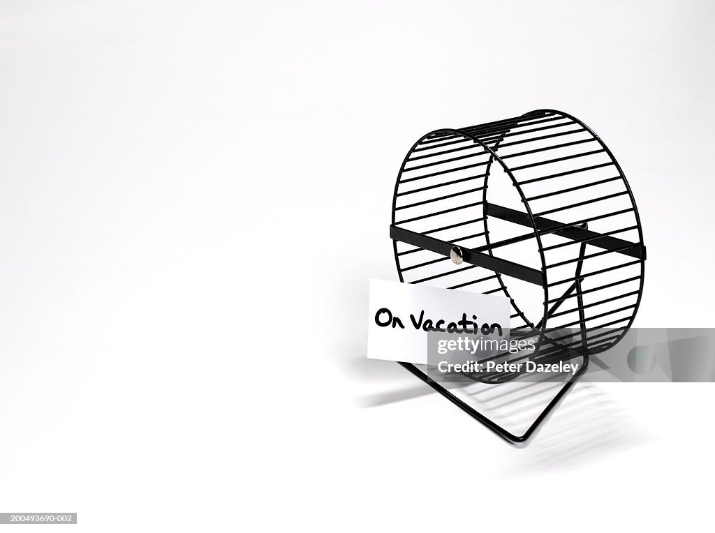 Hamster wheel with 'on vacation' sign, close-up
