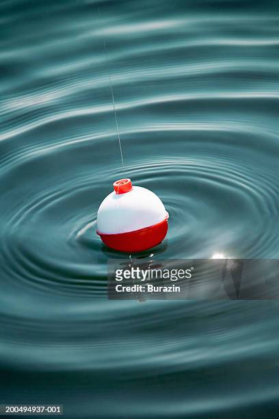fishing float on water, close-up - jig stock pictures, royalty-free photos & images
