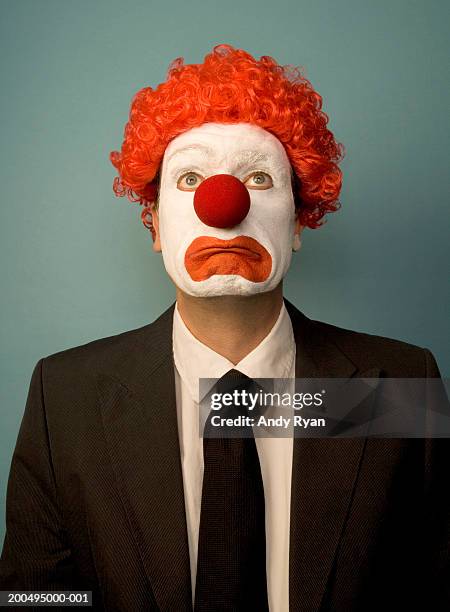 businessman dressed as clown, looking sad, front view, portrait - clown's nose stock pictures, royalty-free photos & images