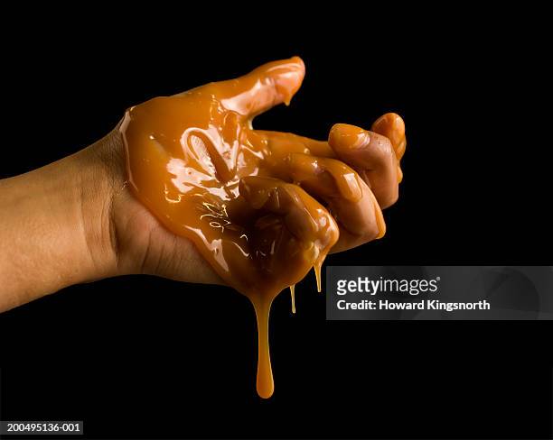 young man with toffee on hand, close-up of hand - sauce stock pictures, royalty-free photos & images