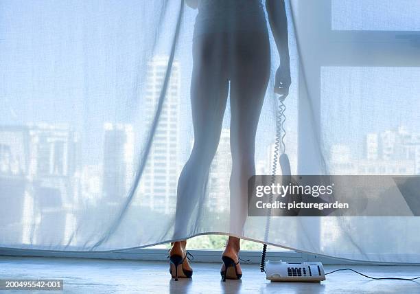 View from behind a woman wearing underwear at an open window stock photo -  OFFSET