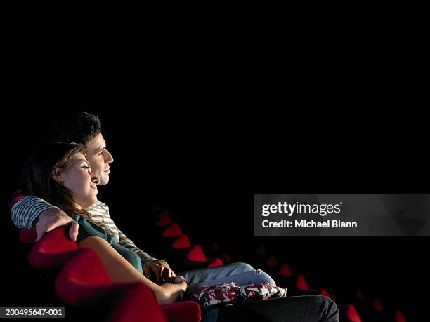 couple in cinema, side view - girlfriends films stock-fotos und bilder