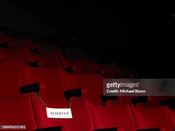 reserved sign on empty cinema seat - posto riservato foto e immagini stock