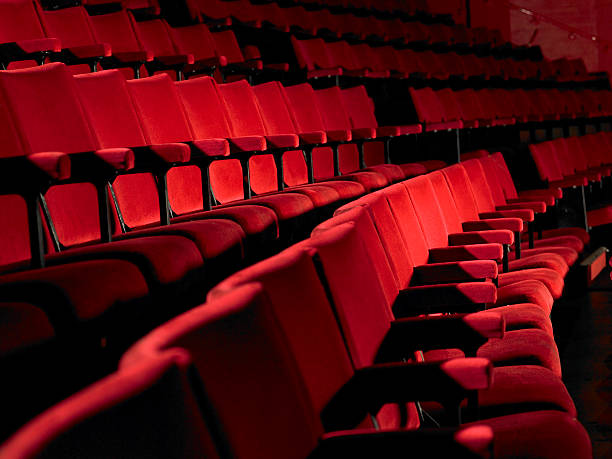 Rows of empty red cinema seats