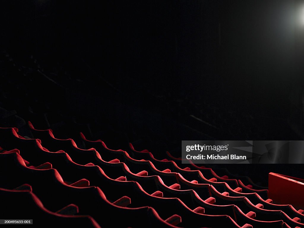 Rows of empty red cinema seats