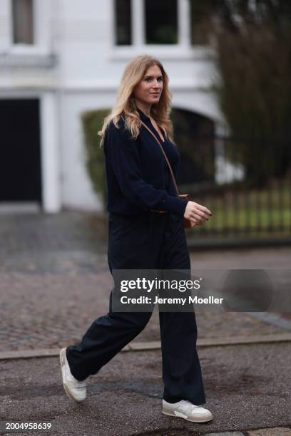 Britta Becker seen wearing OH OK Studio gold zodiac necklace, Twelve by Britta Becker navy blue wool knit sweater, Hermès brown leather belt, Twelve...