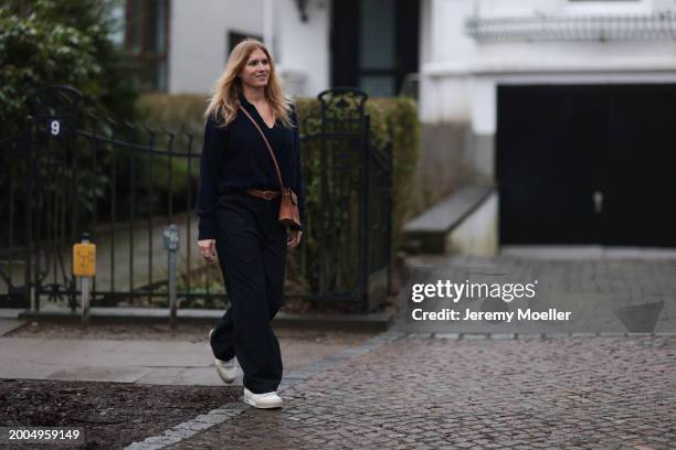 Britta Becker seen wearing OH OK Studio gold zodiac necklace, Twelve by Britta Becker navy blue wool knit sweater, Hermès brown leather belt, Twelve...