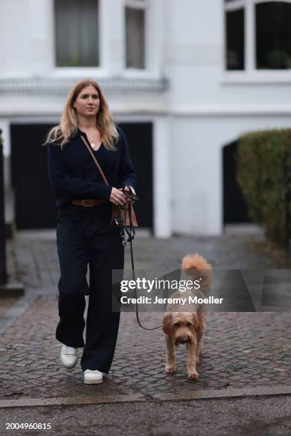 Britta Becker seen wearing OH OK Studio gold zodiac necklace, Twelve by Britta Becker navy blue wool knit sweater, Hermès brown leather belt, Twelve...