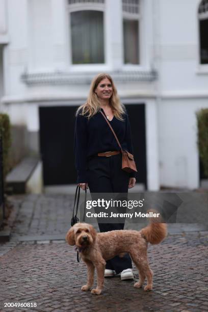 Britta Becker seen wearing OH OK Studio gold zodiac necklace, Twelve by Britta Becker navy blue wool knit sweater, Hermès brown leather belt, Twelve...