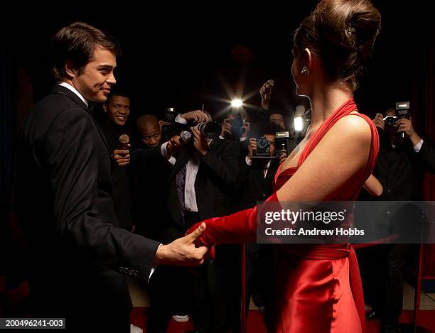 celebrity couple in evening wear being photographed by paparazzi - dinner jacket stock pictures, royalty-free photos & images