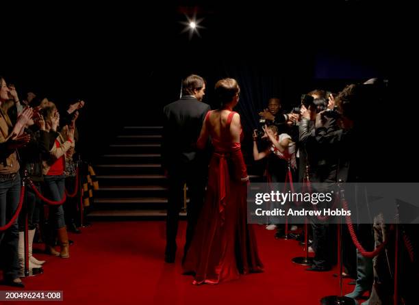 celebrity couple in evening wear walking on red carpet, rear view - red carpet event 個照片及圖片檔