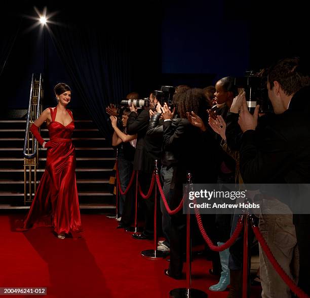 female celebrity in evening  dress posing for paparazzi on red carpet - red carpet stairs stock pictures, royalty-free photos & images