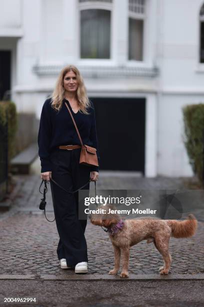 Britta Becker seen wearing OH OK Studio gold zodiac necklace, Twelve by Britta Becker navy blue wool knit sweater, Hermès brown leather belt, Twelve...