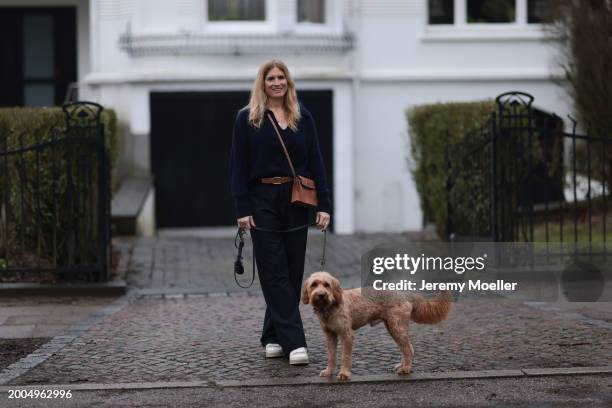 Britta Becker seen wearing OH OK Studio gold zodiac necklace, Twelve by Britta Becker navy blue wool knit sweater, Hermès brown leather belt, Twelve...