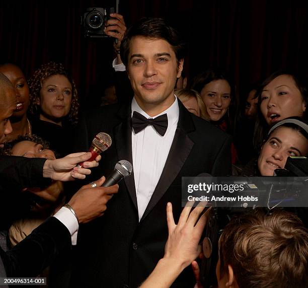 celebrity male in tuxedo talking to fans and media at event, portrait - beauty fan event stock-fotos und bilder