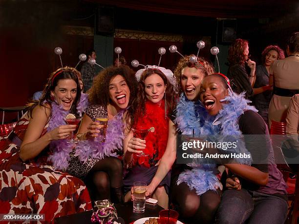 five women in deely boppers and feather boas socialising on hen night - addio al nubilato foto e immagini stock