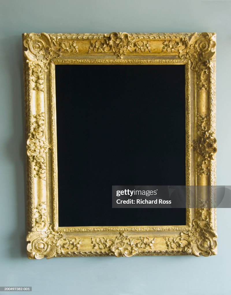 Gold frame hanging on wall