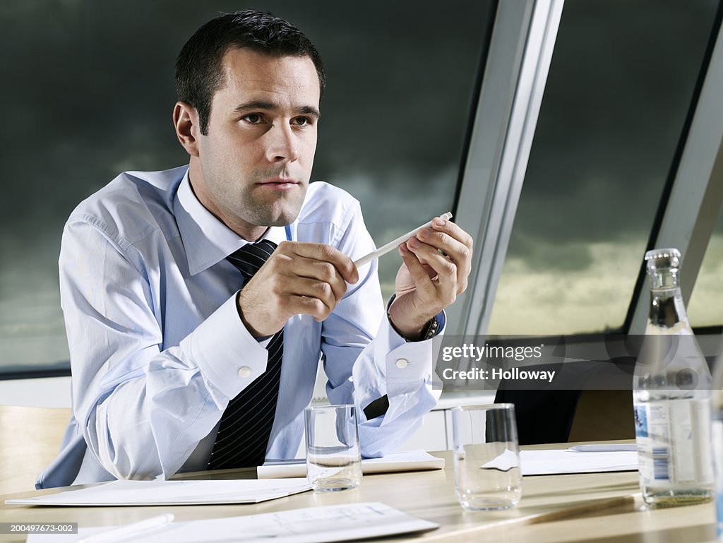 Businessman sitting at conference table