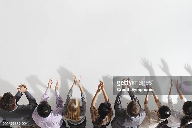 row of businesspeople applauding, elevated view - applauding stock pictures, royalty-free photos & images