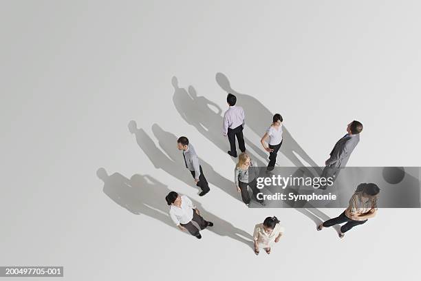 businesspeople looking in different directions, elevated view - confused white background stock-fotos und bilder