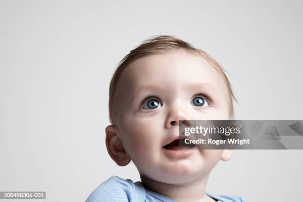 baby boy (6-9 months) looking up, portrait - baby awe stock pictures, royalty-free photos & images