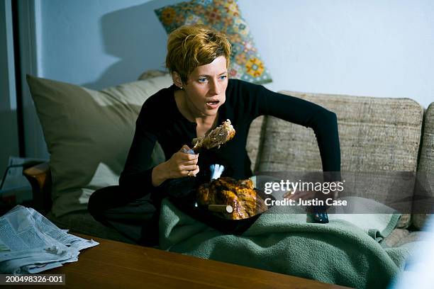 woman eating turkey on couch - chicken leg stock pictures, royalty-free photos & images