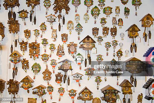 cuckoo clocks on wall - cuckoo clock stock-fotos und bilder