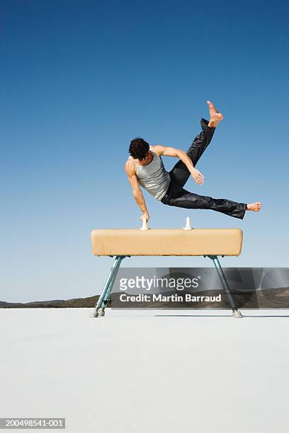 male gymnast performing on pommel horse, outdoors - pommel horse bildbanksfoton och bilder