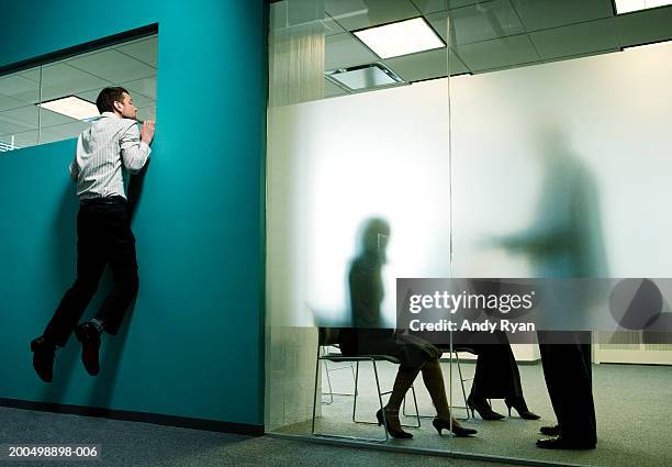 private business meeting behind frosted glass in office, man spying - frosted glass ストックフォトと画像