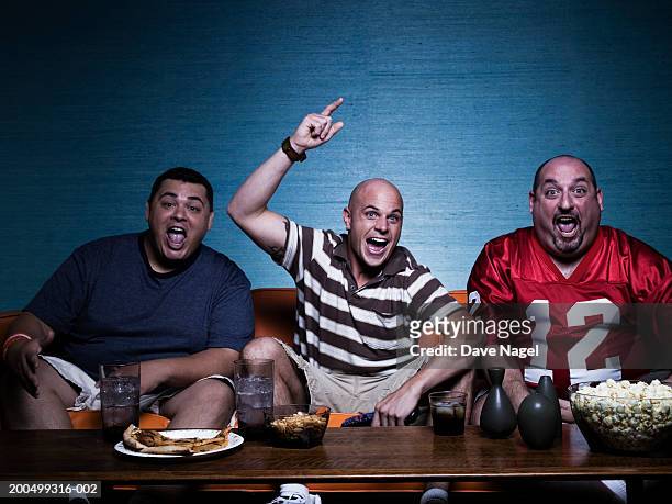three men on sofa, watching television, portrait - sports man cave stock pictures, royalty-free photos & images