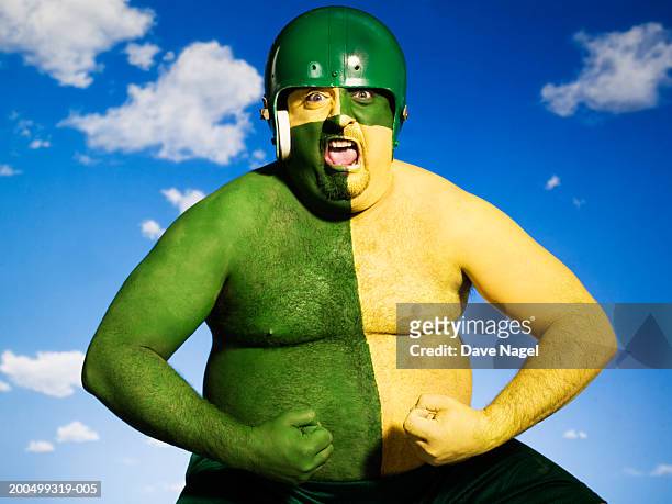 man with face and body painted green and yellow, portrait - bodypainting bildbanksfoton och bilder