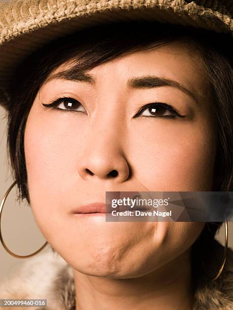 woman pulling face, close-up - female biting lips stockfoto's en -beelden