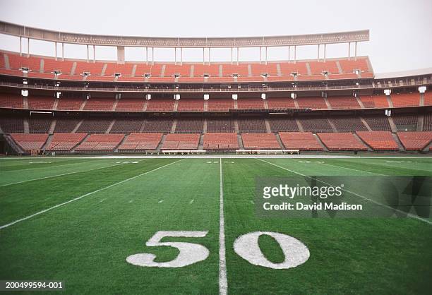 50 yard line on american football field, close-up - american football field stock pictures, royalty-free photos & images