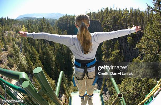 young woman on edge of bungee platform, rear view, (wide angle) - bungee stock pictures, royalty-free photos & images