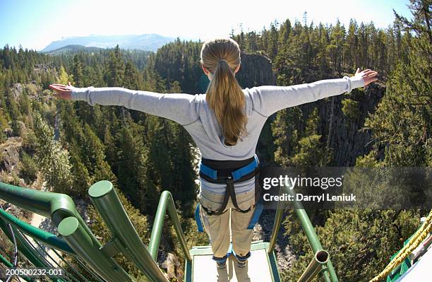 young woman on edge of bungee platform, rear view, (wide angle) - förväntan bildbanksfoton och bilder