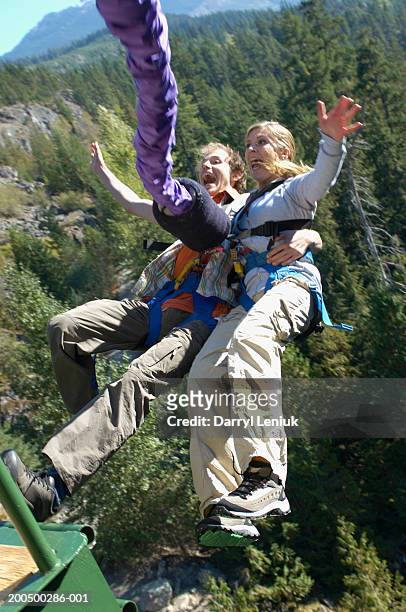 young couple bungee jumping, screaming - bungee jump stockfoto's en -beelden