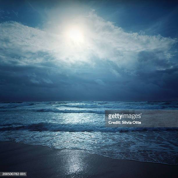moon illuminating beach and atlantic ocean at dusk - praia noite imagens e fotografias de stock