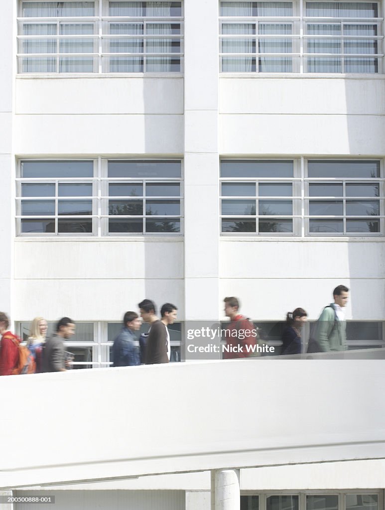 Students on walkways at university, outdoors (blurred motion)